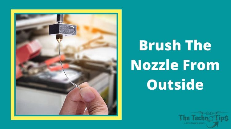 In this image a man hold Brush The Nozzle From Outside-Blocked 3D Printers Nozzle-thetechnotips